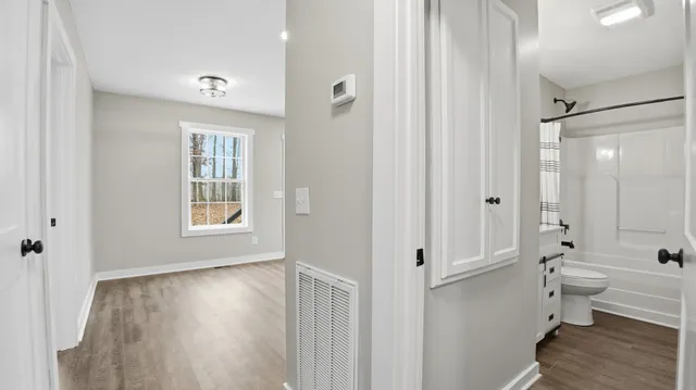 a bedroom with a bed and a potted plant