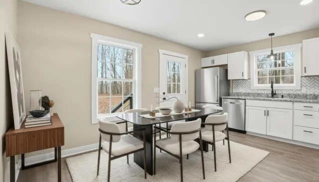 a kitchen with granite countertop white cabinets and white appliances