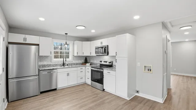 a kitchen with a sink stove and cabinets