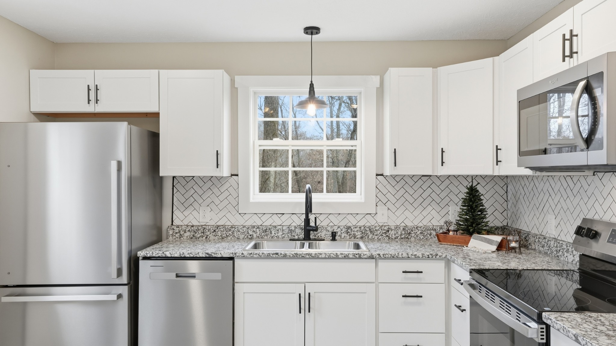 790 Preston Ridge Road Mulberry, TN 37359 - Photo 28 of 44 a kitchen with stainless steel appliances granite countertop a refrigerator a sink a stove and white cabinets