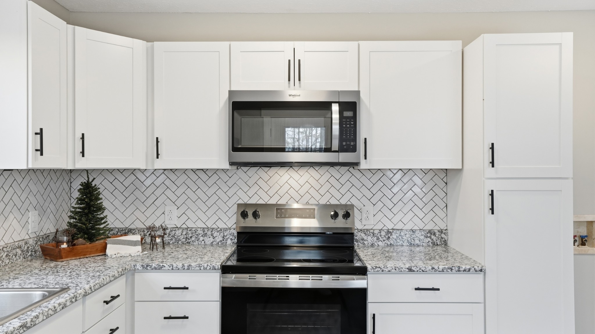 790 Preston Ridge Road Mulberry, TN 37359 - Photo 29 of 44 a kitchen with granite countertop white cabinets and white appliances