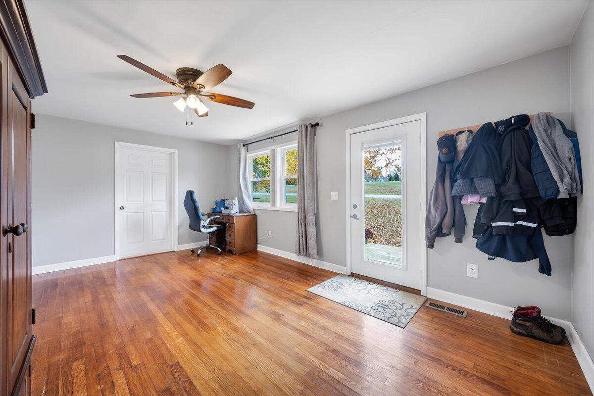 1122 Barberry Road Southeast Floyd, VA 24091 - Photo 4 of 39 a view of a livingroom with hardwood floor and a ceiling fan