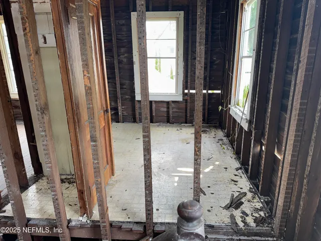 a view of a balcony with furniture and wooden floor