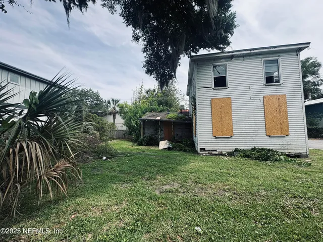 a white house that has sink in front of a house