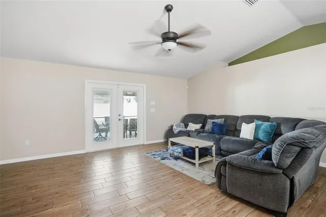 a living room with couches and furniture with wooden floor