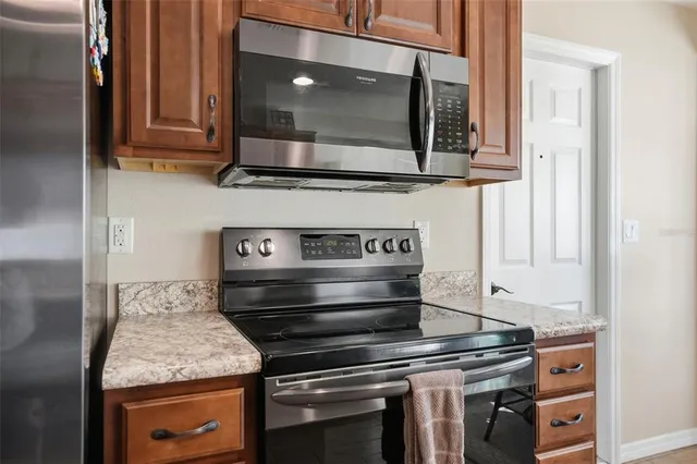 a kitchen with a stove and a microwave