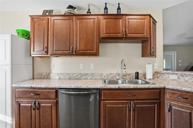 a kitchen with granite countertop a sink and cabinets
