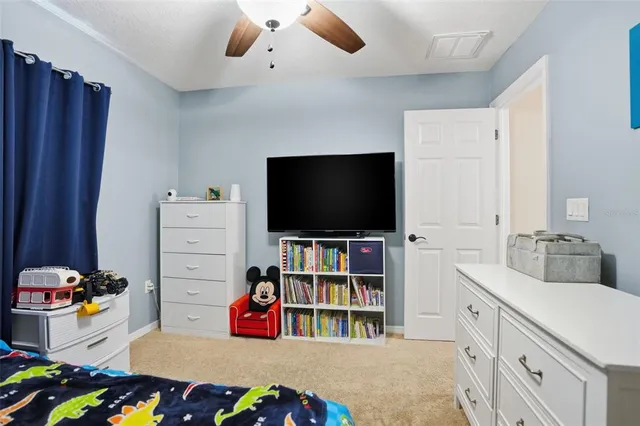 a bedroom with furniture and a flat screen tv