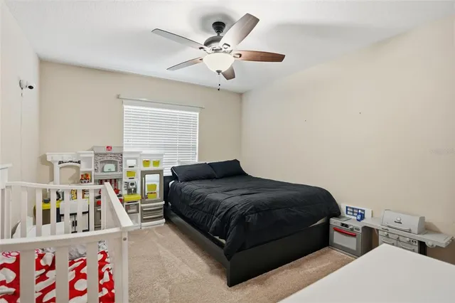 a living room with a bed furniture and a large window