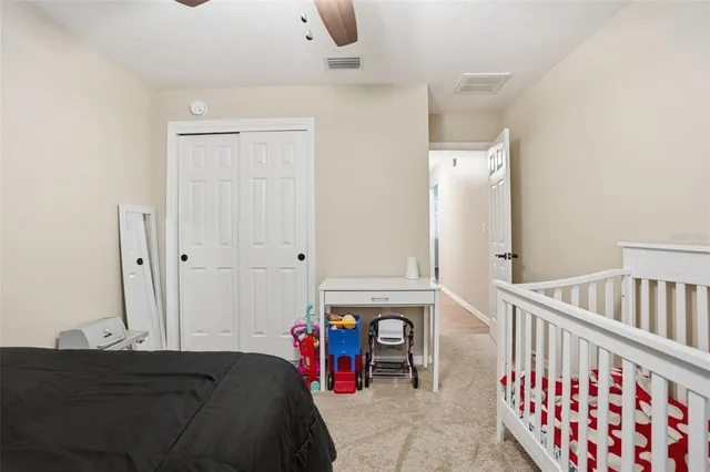a bedroom with furniture and a baby crib