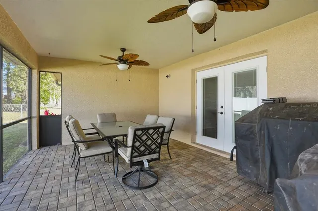 a view of a livingroom with furniture and a floor to ceiling window