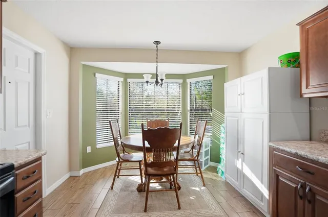 a dining room with furniture and window