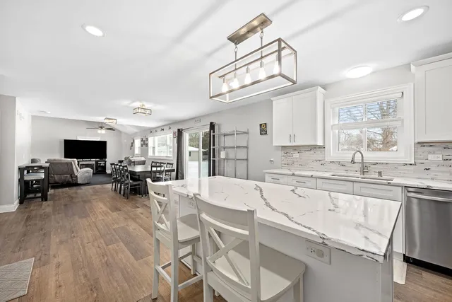 a view of living room with granite countertop furniture and a flat screen tv