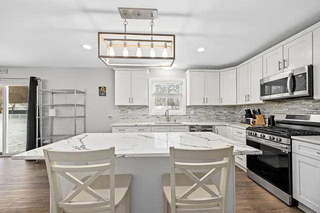 a kitchen with a stove a microwave and cabinets