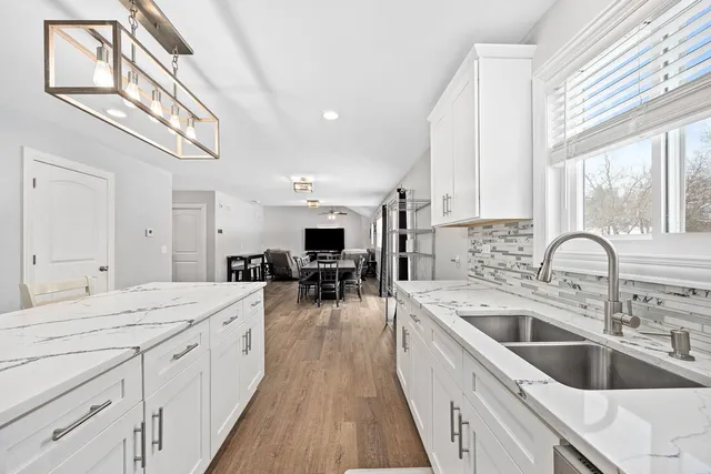 a large kitchen with a large window and stainless steel appliances