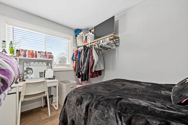 a bedroom with a bed and a desk