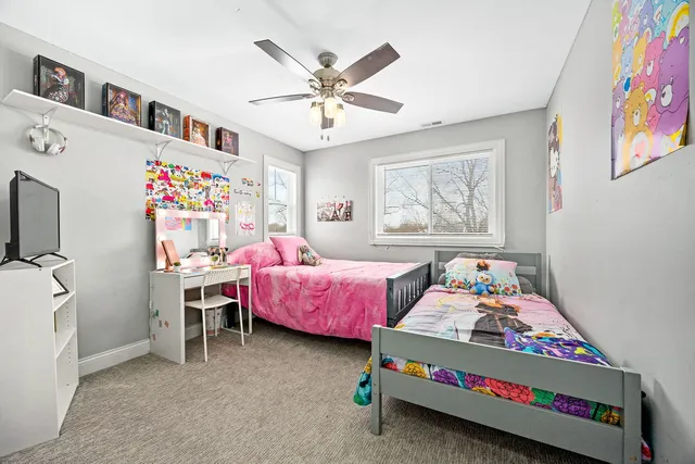 a bedroom with furniture and a baby bed
