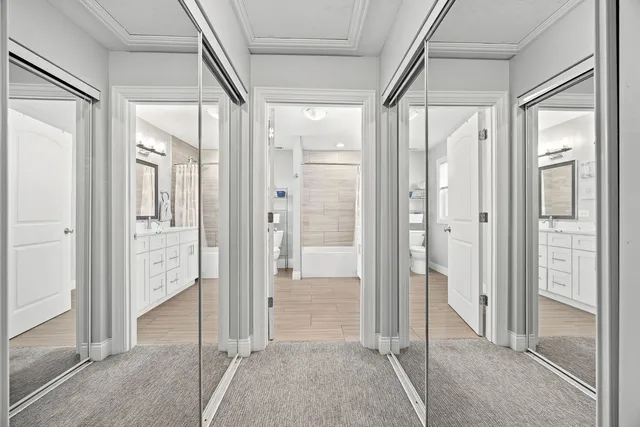 a view of a hallway with wooden floor and glass door