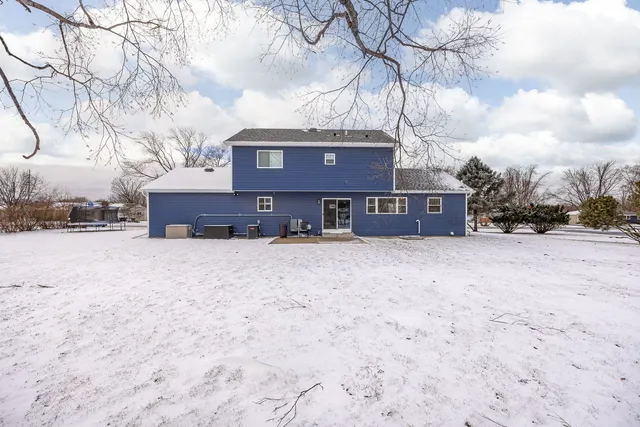 a view of a house with a yard covered in snow