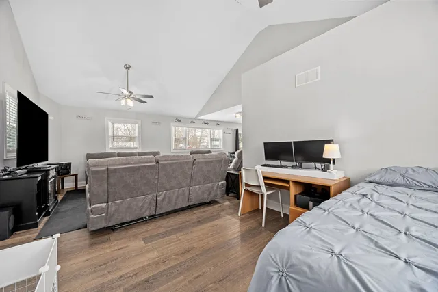 a bed room with a bed and a television