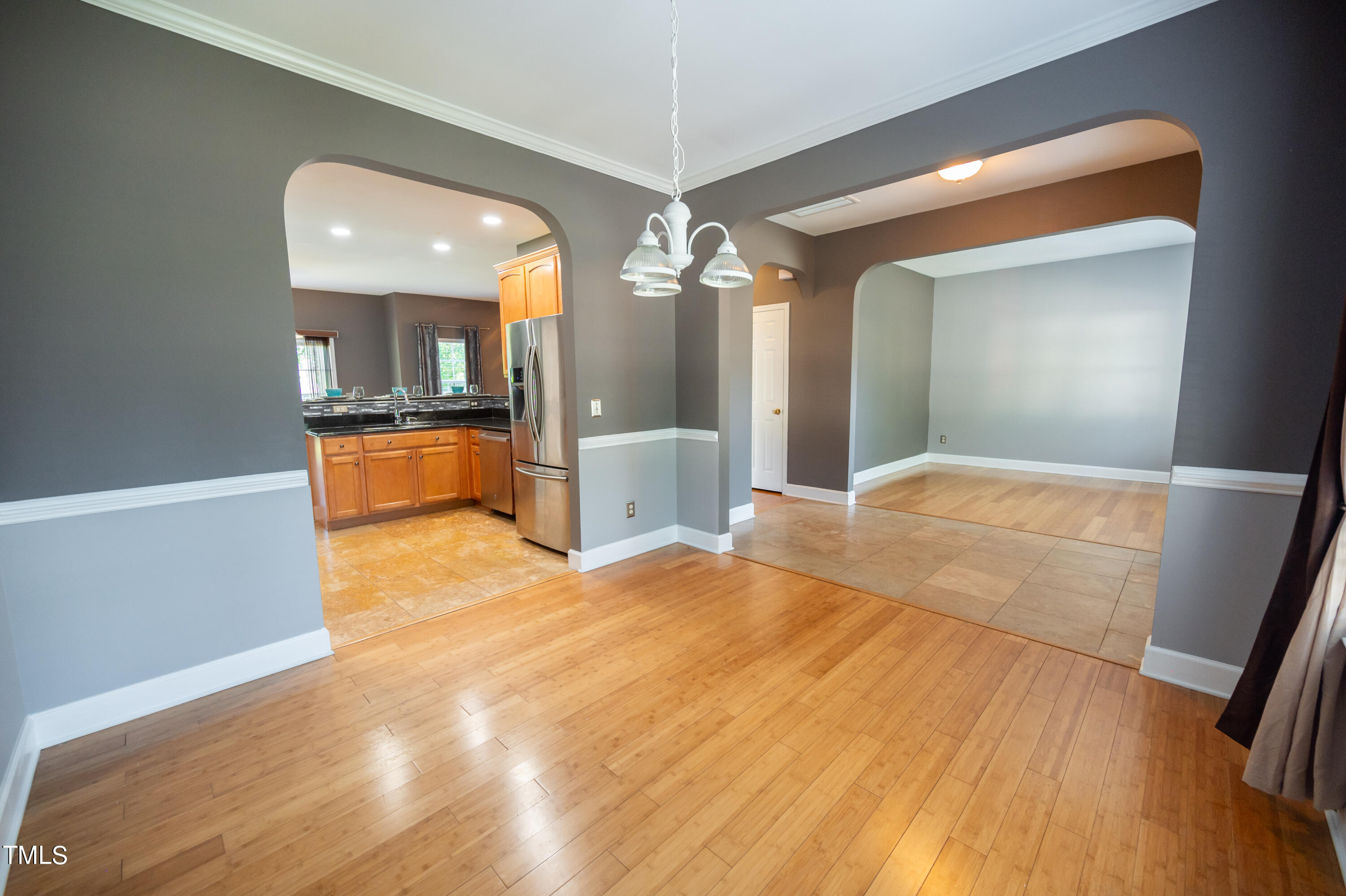 5308 Neuse Forest Road Raleigh, NC 27616 - Photo 13 of 26 a bedroom with a bed and a chandelier