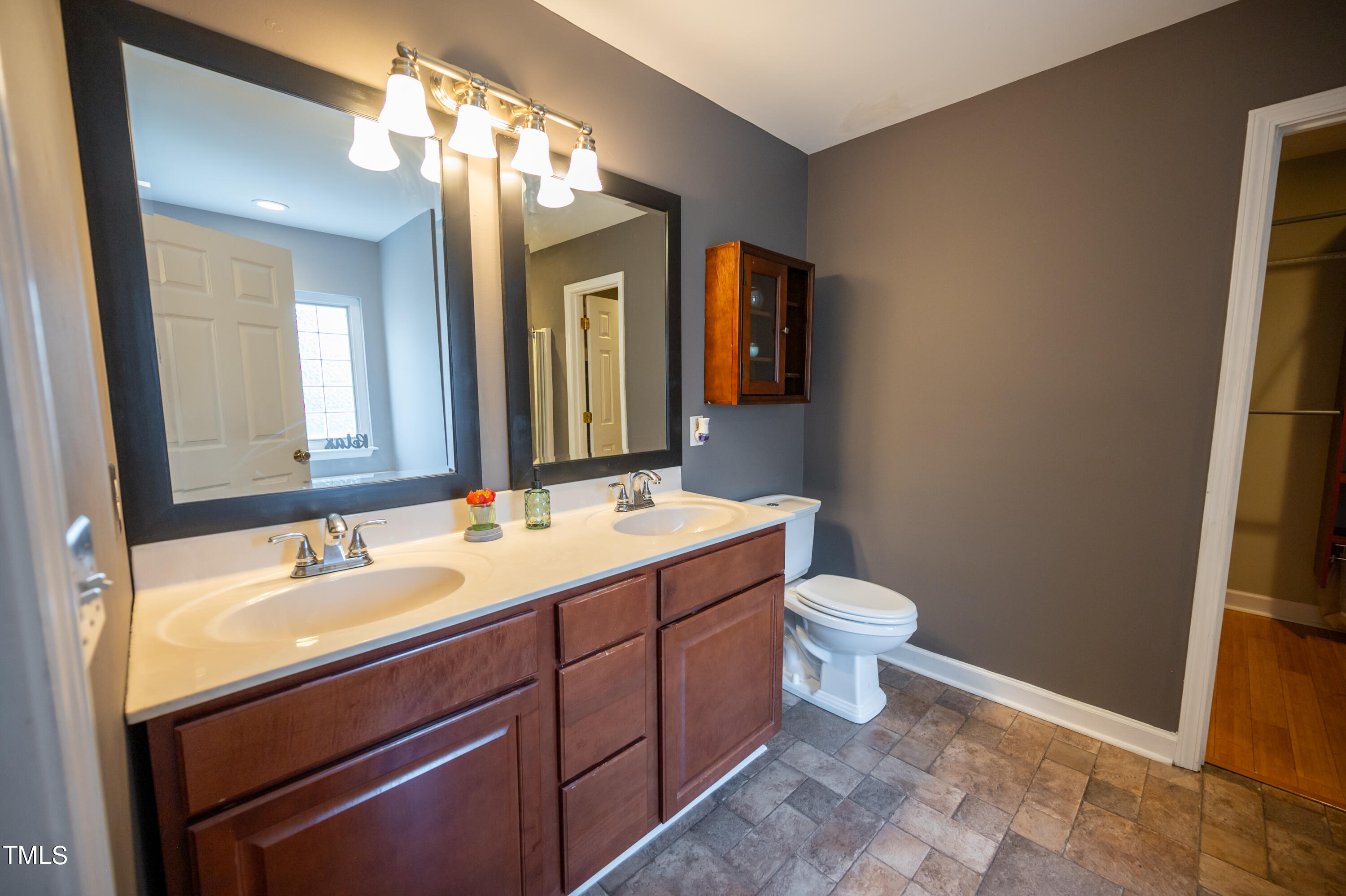 5308 Neuse Forest Road Raleigh, NC 27616 - Photo 17 of 26 a bathroom with a toilet sink and mirror
