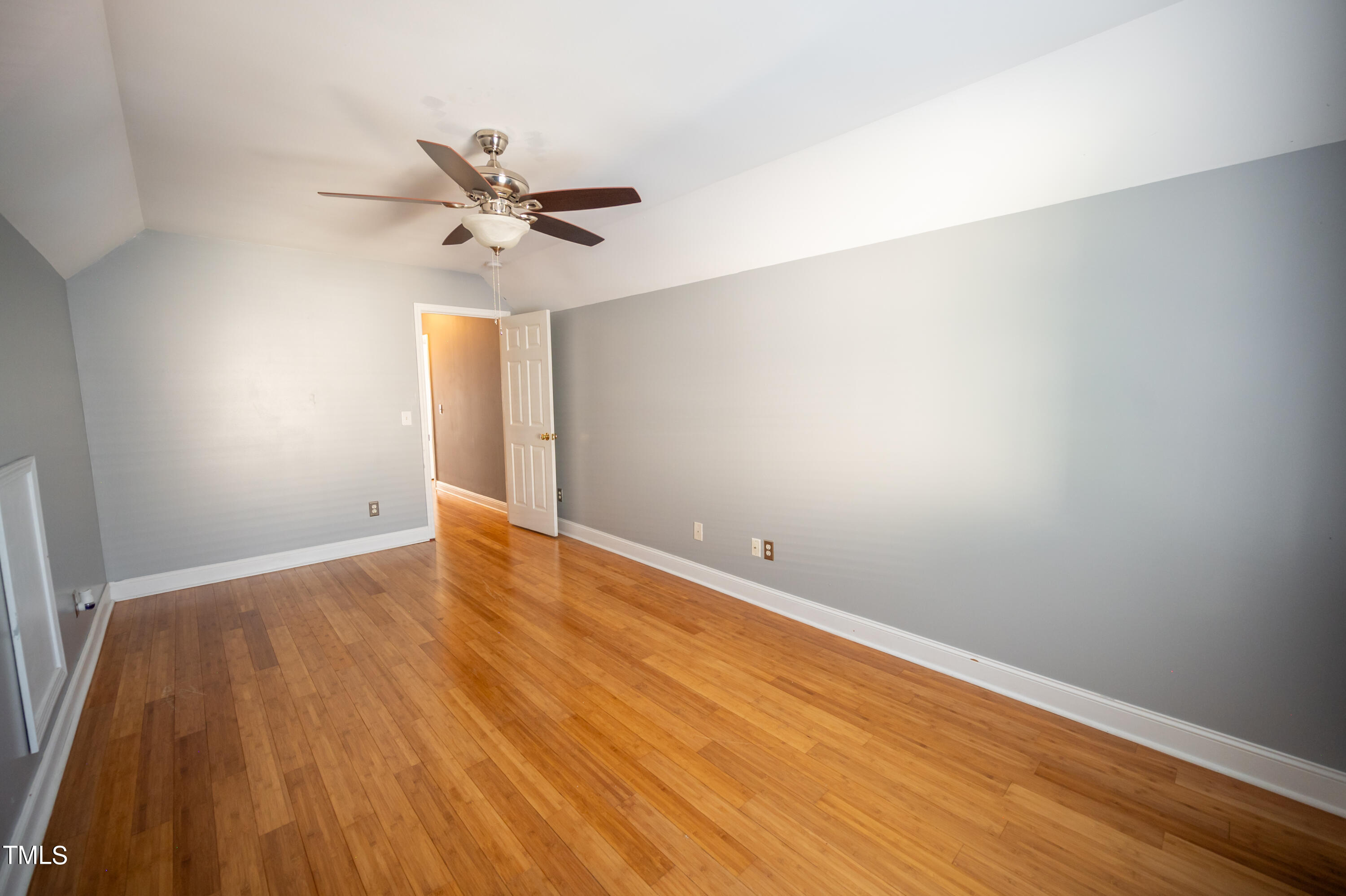 5308 Neuse Forest Road Raleigh, NC 27616 - Photo 22 of 26 an empty room with wooden floor fan and windows
