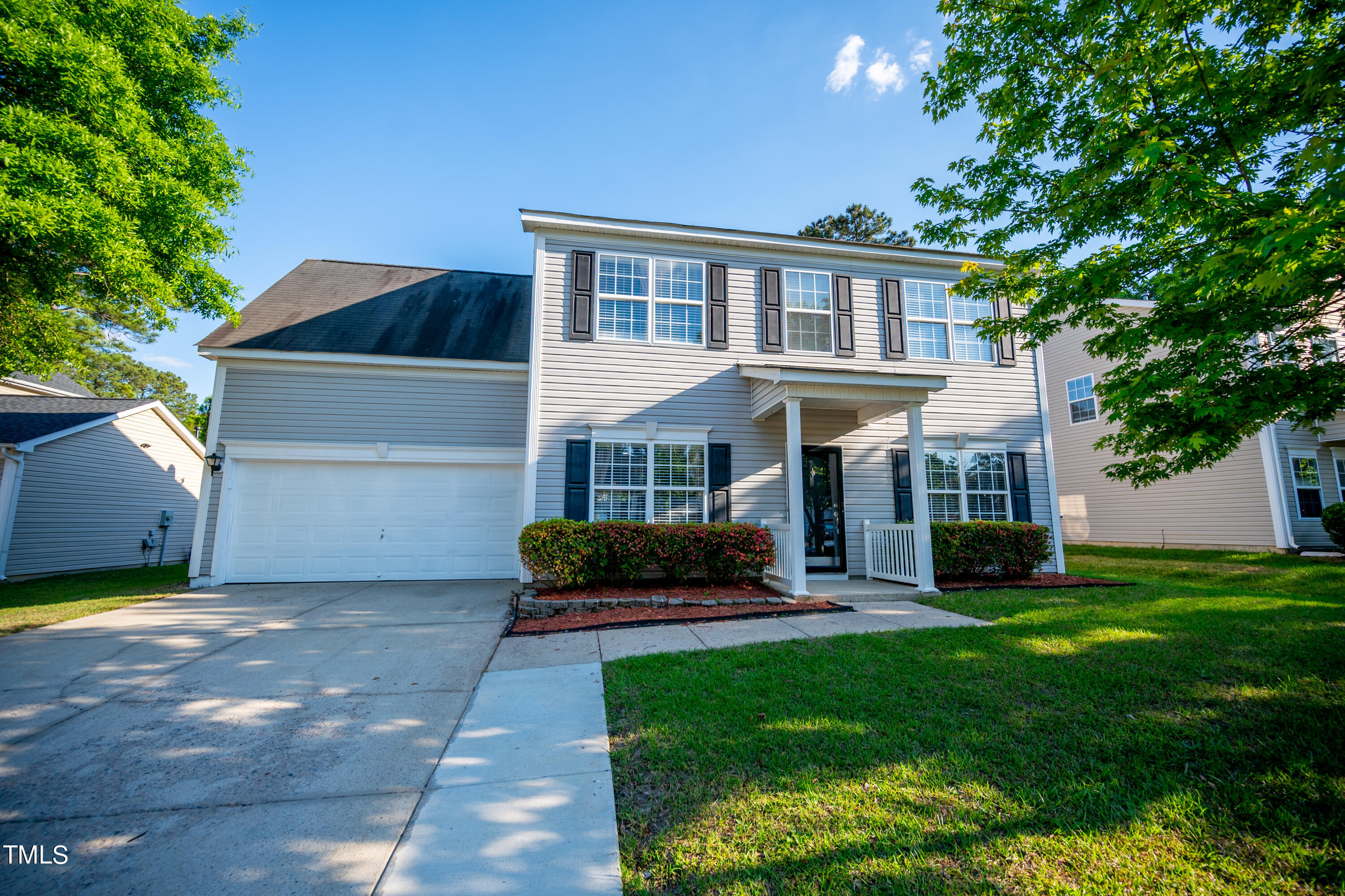 5308 Neuse Forest Road Raleigh, NC 27616 - Photo 25 of 26 a front view of a house with a garden and plants