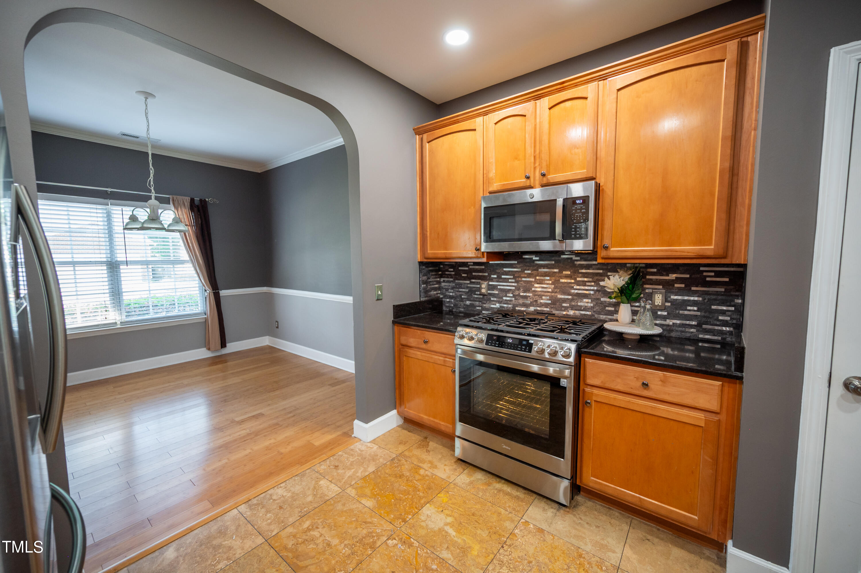 5308 Neuse Forest Road Raleigh, NC 27616 - Photo 9 of 26 a kitchen with stainless steel appliances granite countertop a stove a sink and a microwave