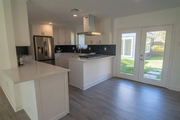a view of a kitchen with a sink and a stove top oven