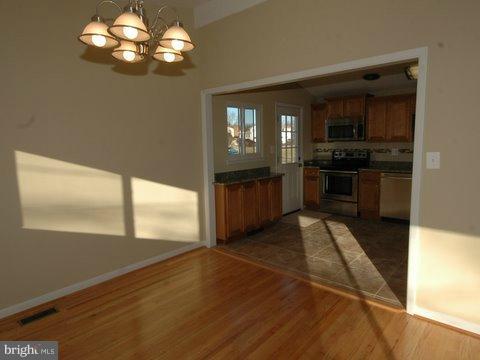 7405 Kathydale Road Pikesville, MD 21208 - Photo 2 of 29 a view of a kitchen with a sink cabinets and stainless steel appliances