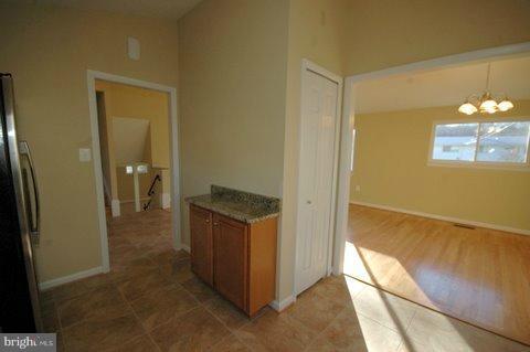 7405 Kathydale Road Pikesville, MD 21208 - Photo 13 of 29 a view of a hallway with wooden floor