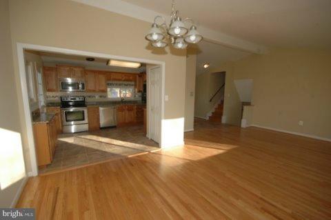 7405 Kathydale Road Pikesville, MD 21208 - Photo 15 of 29 a view of a kitchen with a sink wooden floor and chandelier