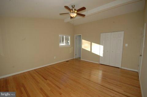 7405 Kathydale Road Pikesville, MD 21208 - Photo 18 of 29 a view of empty room with wooden floor and fan
