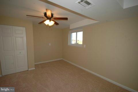 7405 Kathydale Road Pikesville, MD 21208 - Photo 23 of 29 an empty room with windows and fan