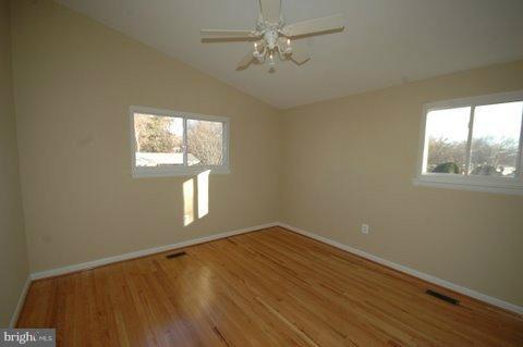 7405 Kathydale Road Pikesville, MD 21208 - Photo 29 of 29 a view of empty room with wooden floor and fan