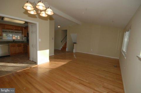 7405 Kathydale Road Pikesville, MD 21208 - Photo 7 of 29 a view of an empty room with a kitchen
