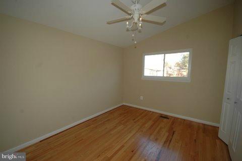 7405 Kathydale Road Pikesville, MD 21208 - Photo 8 of 29 an empty room with wooden floor and windows