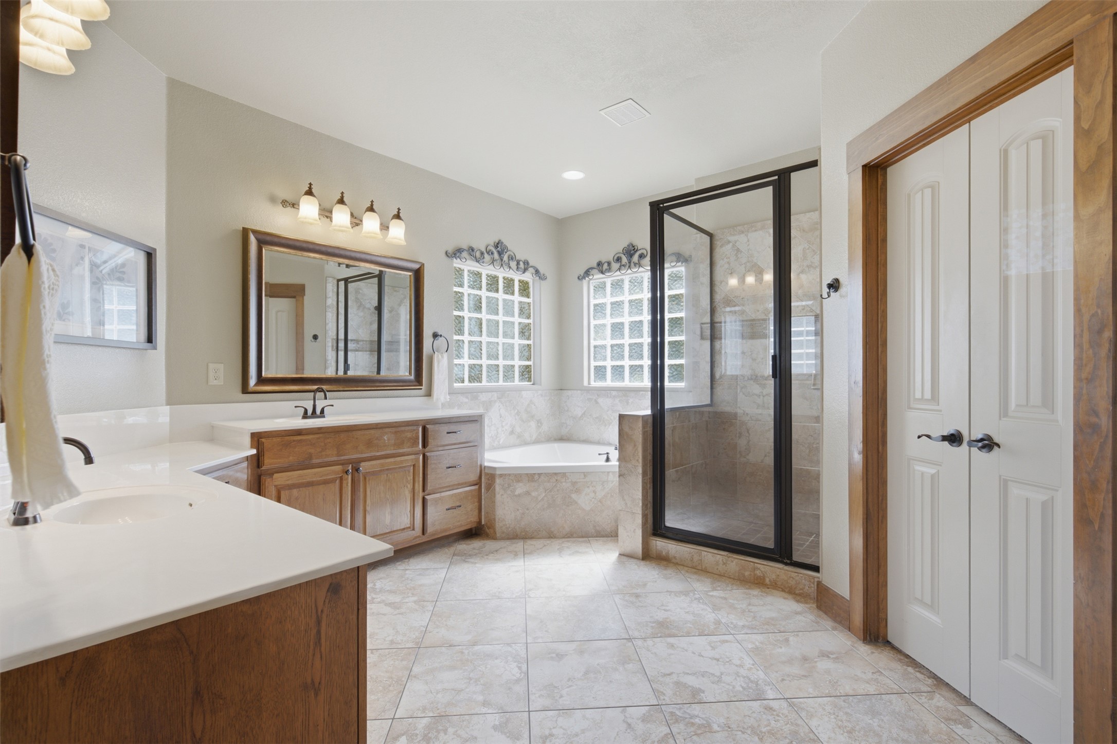 700 Augusta Circle Point Venture, TX 78645 - Photo 10 of 35 Indulge in a primary bathroom featuring a spacious walk-in shower and a corner soaking tub.