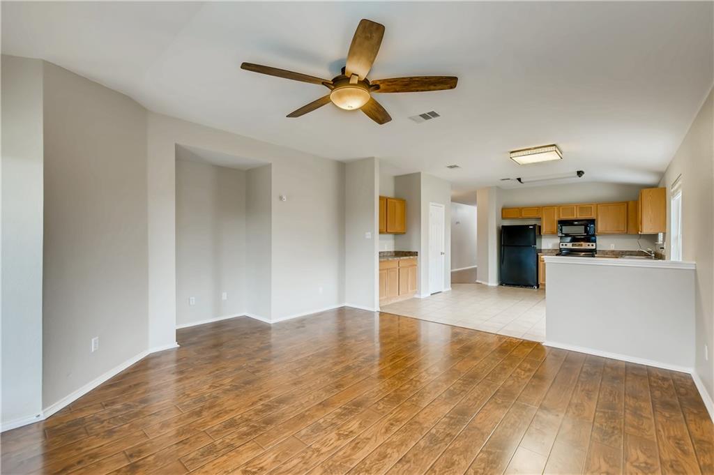 229 Killian Loop Hutto, TX 78634 - Photo 11 of 28 a view of a kitchen with a sink and a refrigerator