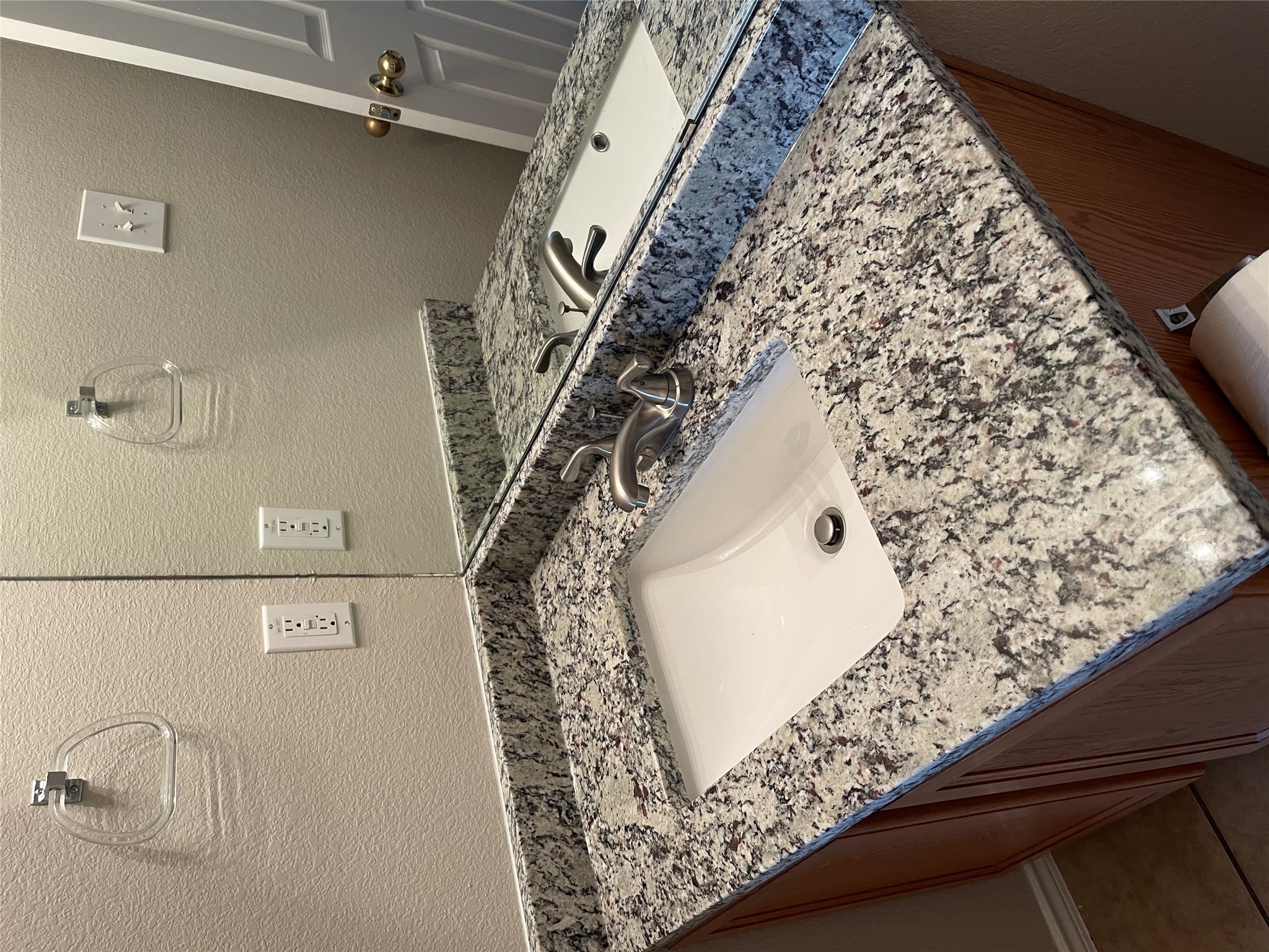 229 Killian Loop Hutto, TX 78634 - Photo 19 of 28 a bathroom with a granite countertop sink and a mirror