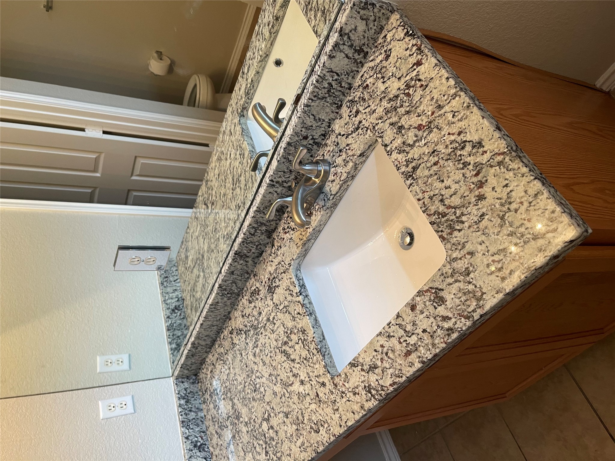 229 Killian Loop Hutto, TX 78634 - Photo 20 of 28 a bathroom with a granite countertop sink and a mirror