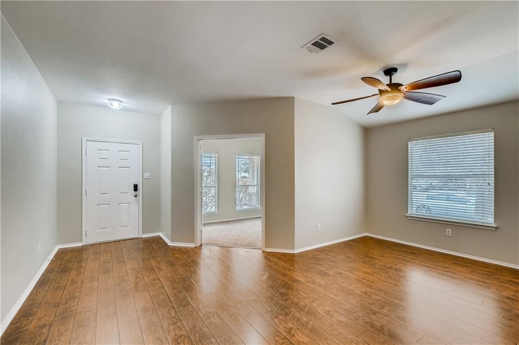 229 Killian Loop Hutto, TX 78634 - Photo 4 of 28 a view of a room with a ceiling fan and a hardwood
