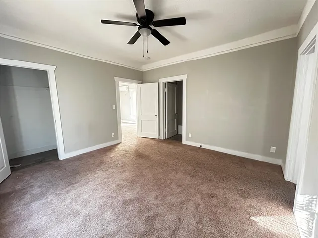 a view of a livingroom with a ceiling fan and window