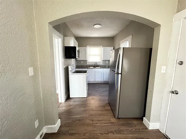 a kitchen with stainless steel appliances a refrigerator and a stove