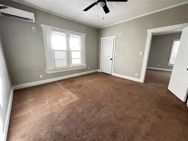 an empty room with windows and closet