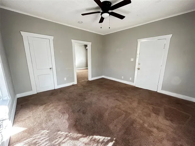 a view of a room with a ceiling fan