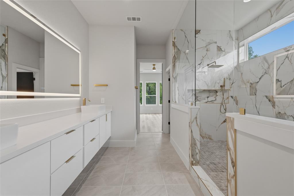 3914 Harlingen Street Dallas, TX 75212 - Photo 21 of 28 a bathroom with a double vanity sink a toilet and shower
