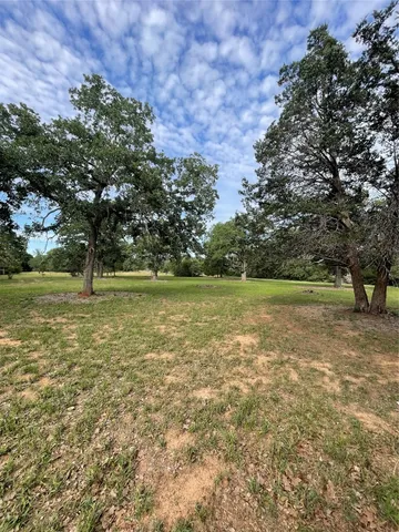 a view of outdoor space with trees all around