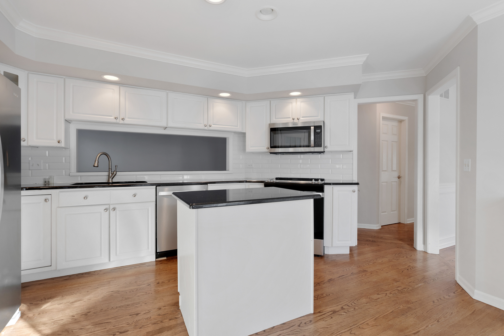 14707 Hollow Tree Road Orland Park, IL 60462 - Photo 12 of 47 a kitchen with stainless steel appliances granite countertop a refrigerator sink and stove